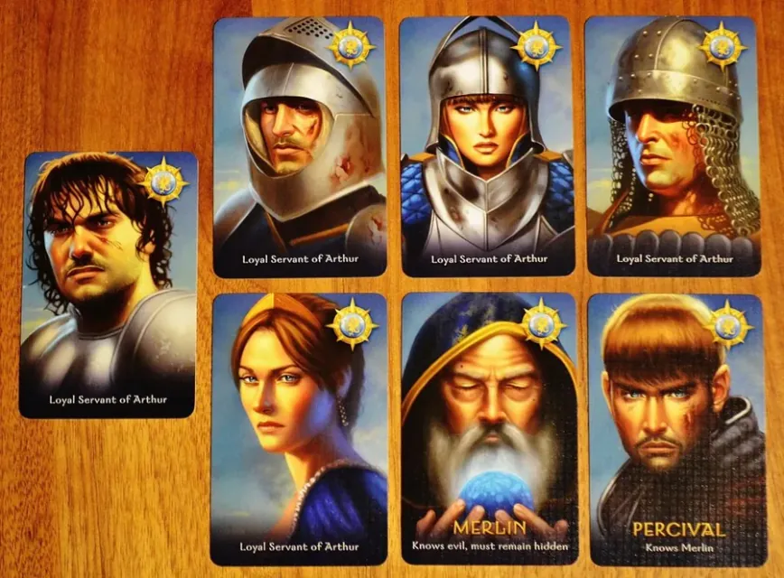 Good character cards: five Loyal Servants of Arthur, Merlin and Percival on a wooden table.