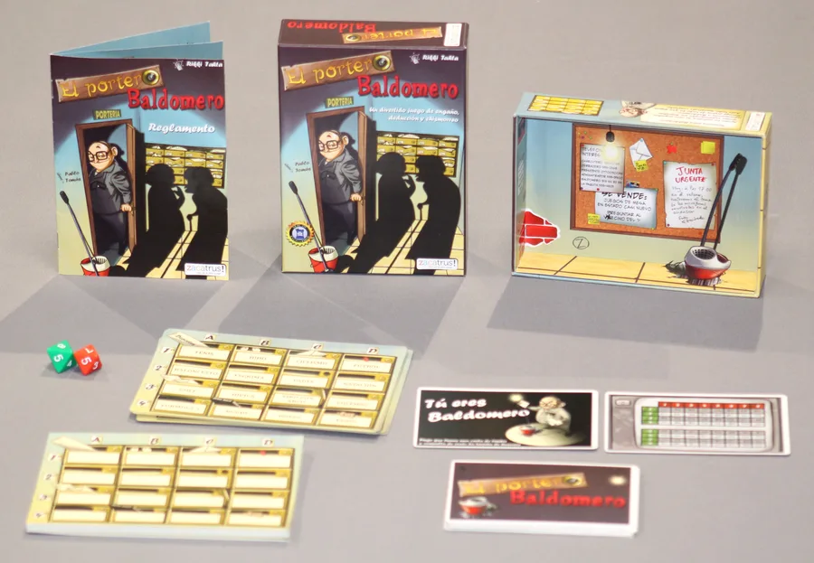 Componentes de El Portero Baldomero sobre una mesa gris: dos tarjetas de buzones con rejillas de palabras, los dos dados de ocho caras, las cartas de timbre, la carta de Baldomero y la caja.