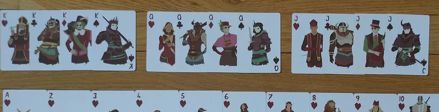 Rows of Regicide cards with the four jacks, four queens and four kings, each with its own character illustration.